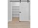 Storage space featuring white barn door with black hardware and built in shelving at 115 Buckskin Dr, Louisburg, NC 27549