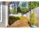 Fenced backyard with mature trees, storage shed, and partial brick patio perfect for outdoor entertaining at 117 Buena Vista Dr, Cary, NC 27513