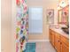 Bathroom with a vessel sink, wood cabinets and colorful painting at 117 Buena Vista Dr, Cary, NC 27513