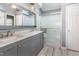 Bathroom with marble double sink vanity, large mirror, glass enclosed shower, and tiled floors at 117 Buena Vista Dr, Cary, NC 27513