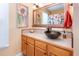 Bathroom with wood cabinets and a dark colored, decorative vessel sink at 117 Buena Vista Dr, Cary, NC 27513