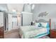 Well-lit bedroom with decoratively painted wall and a doorway that leads to the en-suite bathroom at 117 Buena Vista Dr, Cary, NC 27513