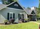 View of home features a well maintained lawn and landscaping, with a sidewalk leading up to the front porch at 117 Buena Vista Dr, Cary, NC 27513