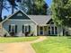 Charming single-story home with a well-maintained lawn, lush landscaping, and a welcoming walkway to the front door at 117 Buena Vista Dr, Cary, NC 27513