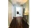 Hallway with wood flooring, decorative hall table and open doorway to the main bedroom at 117 Buena Vista Dr, Cary, NC 27513