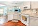 Bright kitchen with modern appliances, granite countertops, and hardwood floors at 117 Buena Vista Dr, Cary, NC 27513