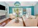 Bright living room features hardwood flooring, vaulted ceilings, fireplace, and large windows at 117 Buena Vista Dr, Cary, NC 27513