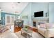 Comfortable living room with a fireplace, hardwood floors, and adjacent dining area in an open-concept design at 117 Buena Vista Dr, Cary, NC 27513