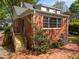 Brick home featuring a brick patio and new wooden staircase and a lush landscaped garden at 119 Montgomery St, Raleigh, NC 27607