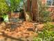 Brick patio with outdoor seating, bird bath, and garden and staircase in a fenced yard at 119 Montgomery St, Raleigh, NC 27607