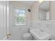 Bright, tiled bathroom with a window and updated fixtures in neutral tones at 119 Montgomery St, Raleigh, NC 27607