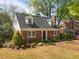 Charming brick home featuring dormer windows and a well-manicured front yard at 119 Montgomery St, Raleigh, NC 27607