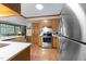 Galley kitchen with stainless appliances and wood cabinets is connected to the living room beyond at 119 Montgomery St, Raleigh, NC 27607