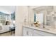 Modern bathroom featuring double sinks, white cabinets and a large mirror at 1204 Pavo Path, Wendell, NC 27591