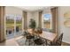 Bright dining room with a wooden table and chairs, sliding glass doors to patio at 1204 Pavo Path, Wendell, NC 27591