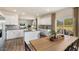 Open-concept kitchen and dining area, stainless steel appliances, and large windows at 1204 Pavo Path, Wendell, NC 27591