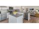 Modern kitchen featuring an island, granite countertops, and stainless steel appliances at 1204 Pavo Path, Wendell, NC 27591