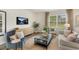 Comfortable living room with stylish furnishings, a modern media center, and lots of light at 1204 Pavo Path, Wendell, NC 27591