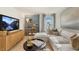 Bright living room featuring a sectional sofa, entertainment center, and large windows at 1204 Pavo Path, Wendell, NC 27591