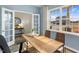 Office with French doors, a wood desk, two chairs, and a large window at 1204 Pavo Path, Wendell, NC 27591