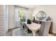 Elegant dining room featuring a table with seating for six, a window view, and stylish decor at 1208 Pavo Path, Wendell, NC 27591