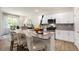 Bright kitchen island with granite counters, modern appliances, and counter seating at 1208 Pavo Path, Wendell, NC 27591