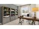 Well-lit office space showcasing built-in bookshelves, a modern desk, and natural light at 1208 Pavo Path, Wendell, NC 27591