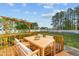 Wooden deck with a pergola featuring a dining table and backyard views at 1209 Huffington Oak Dr, Willow Springs, NC 27592
