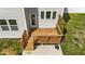 Aerial view of wood deck with stairs leading down to concrete pad at 1209 Huffington Oak Dr, Willow Springs, NC 27592