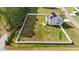 A wide-angle aerial view shows the spacious, fenced-in backyard and deck at 1209 Huffington Oak Dr, Willow Springs, NC 27592