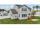 The home features a backyard with a wooden deck, white fence and lush lawn at 1209 Huffington Oak Dr, Willow Springs, NC 27592