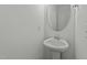 A clean white pedestal sink and oval mirror create a simple, modern powder room at 1209 Huffington Oak Dr, Willow Springs, NC 27592