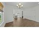 Open concept dining area with hardwood floors and a view into the modern kitchen at 1209 Huffington Oak Dr, Willow Springs, NC 27592