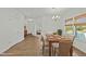 Sunlit dining room with hardwood floors, chandelier, and a glimpse into the living room at 1209 Huffington Oak Dr, Willow Springs, NC 27592