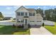 Well-maintained two-story home with a two-car garage and a neatly landscaped front yard at 1209 Huffington Oak Dr, Willow Springs, NC 27592