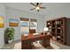 Comfortable home office featuring a wooden desk, shelving unit, and a view of the neighborhood at 1209 Huffington Oak Dr, Willow Springs, NC 27592