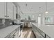 A modern kitchen with white cabinets, stainless steel appliances, a gray backsplash, and a large island at 1209 Huffington Oak Dr, Willow Springs, NC 27592