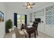 Home office featuring built-in bookshelves, a ceiling fan, and a view to the yard at 1209 Huffington Oak Dr, Willow Springs, NC 27592