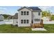 Back of home, featuring a wooden deck, solar panels, and fenced backyard at 1209 Huffington Oak Dr, Willow Springs, NC 27592