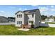 Rear exterior of the home featuring solar panels, a wood deck, and white fence at 1209 Huffington Oak Dr, Willow Springs, NC 27592