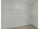 Spacious walk-in closet featuring multiple levels of wire shelving for ample storage at 1209 Huffington Oak Dr, Willow Springs, NC 27592