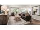 Open-concept living room with modern decor, stylish furniture, and ample natural light creating an inviting atmosphere at 1216 Pavo Path, Wendell, NC 27591