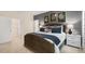 Beautifully staged main bedroom suite with woven headboard, neutral walls, and walk-in closet at 1216 Pavo Path, Wendell, NC 27591