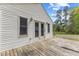 Exterior shot of the home's back deck, accessed by glass paneled doors and windows at 124 Maluli Dr, Oxford, NC 27565