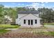 Rear exterior view with wood deck, patio, and lawn, offering ample outdoor enjoyment at 124 Maluli Dr, Oxford, NC 27565