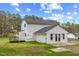 Back of house showcasing expansive lawn, patio area, and wood deck at 124 Maluli Dr, Oxford, NC 27565