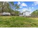 Large backyard with lush green lawn and treeline, creating a peaceful setting at 124 Maluli Dr, Oxford, NC 27565