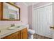Cozy bathroom featuring a wood vanity, toilet, and a large closet, offering ample storage at 124 Maluli Dr, Oxford, NC 27565