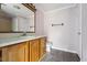 Bathroom features wood vanity with a mirror, complimented by light pink walls and gray floors at 124 Maluli Dr, Oxford, NC 27565
