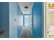 Hallway with neutral carpet, blue walls, and white trim, offering a serene transition between the rooms at 124 Maluli Dr, Oxford, NC 27565